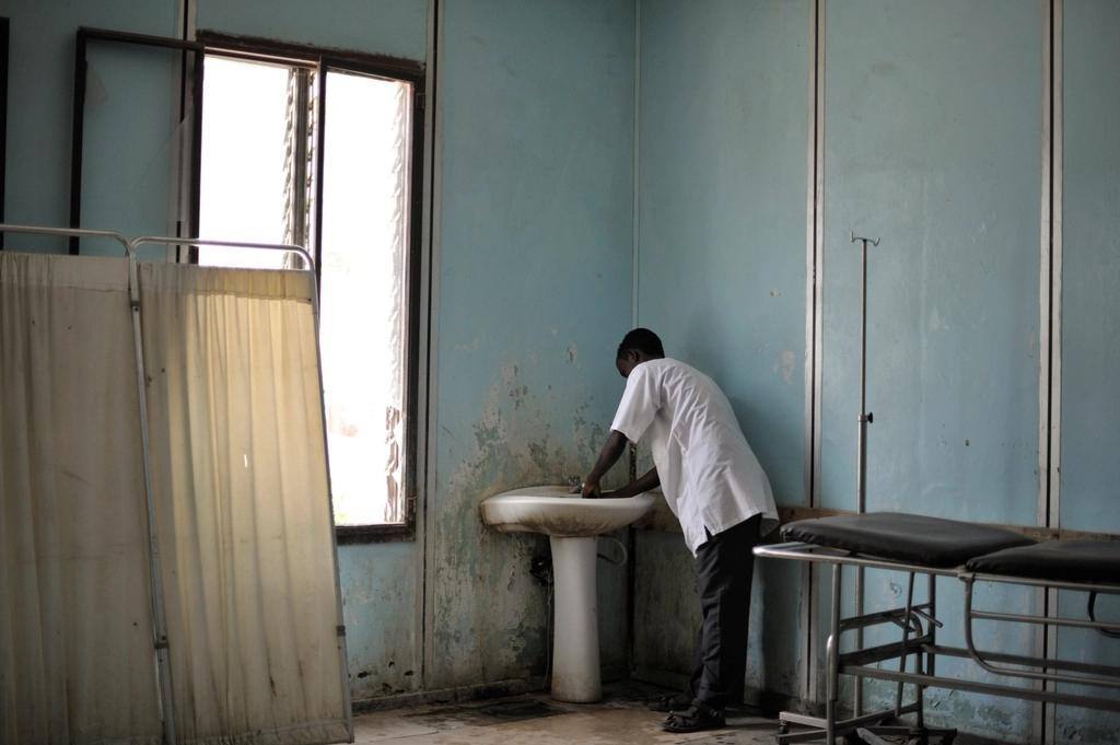 A nurse washes his hands in an emergency ward in Somalia.